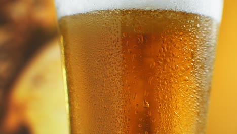 Cold-Light-Beer-in-a-glass-with-water-drops.-Craft-Beer-close-up.-Rotation-360-degrees.